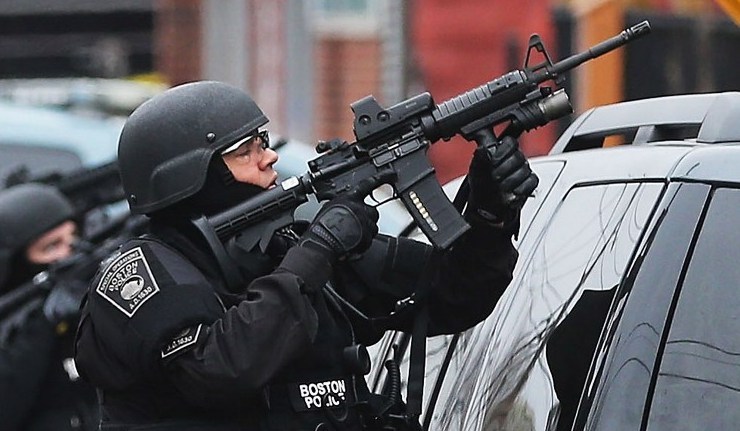 Boston SWAT team member takes up as posistion as they search for 19-year-old bombing suspect Dzhokhar A. Tsarnaev.